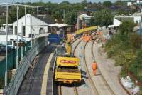 A view north towards Chorley station on 11 September 2016 as an RRV with trailer returns to the station site having unloaded some spoil. The new down platform face is still under construction but now has a yellow barrier fence attached to it.<br><br>[John McIntyre 11/09/2016]