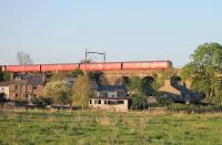 The red livery of a Royal Mail Class 325 parcels EMU is enhanced by the setting sun as it crosses the River Conder at Galgate, heading from Sheildmuir to Warrington on 9th May 2016.  <br><br>[Mark Bartlett 09/05/2016]