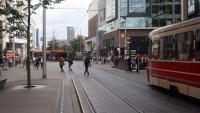 A route 16 GTL type tram (right) sets out south from Centruum with a route 15 modern Avenio type tram in the background. Below is Spui station in the Tramtunnel. One of the  entrances to the station below can be seen in front of the route 16 tram. Most route 16s turn round at the Stadhuis but some, such as this one, continue to the Grote Kerk to turn.<br><br>[Ewan Crawford 04/09/2016]