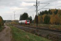 Upptåget 2 car Class X52 running at 200kph south-bound towards the camera. This is the local stopping service north from Uppsala Central with 11 local stations over 106km to Gävle. The service is provided until 2021 by DSB Uppland a subsidiary of the Danish national train operator on behalf of Upplands Lokaltrafik (UL) the public transport agency of local authourities in Uppsala County.<br>
Notice anything familiar about train running compared to GB practice?<br>
 Note the catenary tensioning system and the auxiliary power supply 20kVA with three cables above the traction power supply 15 kVA 16.7 Hz on shared stanchions. In the left background is a signal controlling the facing crossover.<br><br>[Charlie Niven 06/10/2010]