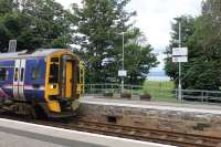 158704, working from Wick to Inverness, calls at Tain on 22nd July 2016. Through the gap in the trees the Dornoch Firth can be seen.<br><br>[Mark Bartlett 22/07/2016]