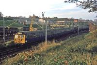 This photo shows the rear of a local train from Clacton and Walton as it approaches Colchester St Botolphs station (later renamed Colchester Town) on 10th November 1977. To the left is the station’s lower freight yard which remained in operation until 1982. In the right foreground is the track bed of a former stabling siding once used by Brightlingsea trains. <br><br>[Mark Dufton 10/11/1977]