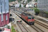 Veteran SBB electric 11244 departs from Locarno with the <I>Wilhelm Tell Express</I> to Lucerne in June 2016. This runs hourly via the scenic Gotthard Pass (Note the second coach is an observation car) and will continue until the Gotthard Base Tunnel opens to passenger trains in late 2016. <br><br>[Mark Bartlett 24/06/2016]