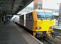 A track machine awaits departure from Nuneaton platform 1 on 5 August 2016. I had arrived on the platform through the glass door on the left, and saw red signals at both ends of the platform. I had to guess which way the machine would leave - as you can see from the tail light, my 50/50 chance went wrong. <br><br>[Ken Strachan 05/08/2016]