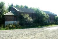 The old goods yard at Currie, looking south from the station site in September 2003. The station had closed to passengers in 1943 with the Balerno line closing completely in 1967. The large surviving goods shed had been refurbished and put to use as a storage facility by the local council.<br><br>[John Furnevel 22/09/2003]