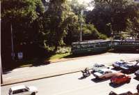 Photographed from a hotel window above a busy street tram type Be 4/4 runs across a major road junction onto dedicated tracks in central Basel. In 1999 the trams were repainted in a light green livery. BVB, a self-governing public corporation, also has tram lines that run from Basel into neighbouring countries France and Germany.<br><br>[Charlie Niven /05/1992]