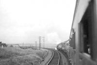 A view from a train, showing Caley 'Jumbo' 57266 at the head of the SLS <I>Paisley - Barrhead District Tour</I> of 1 September 1951. The special is on the leg from Paisley Gilmour Street to Kilbarchan and is seen here on the curve between Cart Junction and Johnstone North. [Ref query 56304] <br><br>[G H Robin collection by courtesy of the Mitchell Library, Glasgow 01/09/1951]