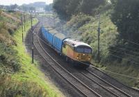 Colas 56105 powers through the reverse curves near Forton with a special working of nine refurbished timber wagons. The train ran from Cardiff Canton to Carlisle Yard on 23rd September 2016 but the Class 56 failed near Oxenholme and was rescued by a WCRC Class 47.<br><br>[Mark Bartlett 23/09/2016]