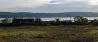 After creating a certain amount of mayhem on the West Highland today, the late running (8 hours) Bridge of Orchy to Mossend PW rails train passes Cardross. The 'Alcans' were cancelled and Pathfinder tour hugely delayed.<br><br>[Ewan Crawford 03/10/2016]