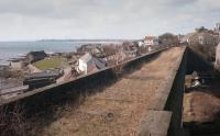 Looking west over Largo Viaduct in 1984 with the station site behind the camera and the chimney of Methil Power Station on the horizon.  A couple of sleepers remain in place.<br><br>[Bill Roberton //1984]