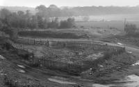 View over the site of the Randolph Pit with a plated-over shaft fenced off in the centre of the frame.  The siding encircled the area.  No trace of the pit survives due to opencast working of the location.<br><br>[Bill Roberton //1990]