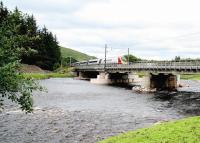 The 0843 London Euston - Edinburgh Waverley speeds north over Lamington Viaduct on 27 July 2016. Note the sizeable spoil heaps standing on the south bank of the Clyde, a leftover from the considerable excavation and construction work carried out on the viaduct during closure of the line in January and February following damage caused by storm <I>Frank</I>. [See image 54263]   <br><br>[John Furnevel 27/07/2016]