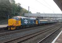 37403 <I>Isle of Mull</I> returned to main line use with the Cumbrian Coast fleet of Class 37/4s in July 2016. It is owned by the SRPS and was based at Boness for several years [See image 25834] but is now on long term loan to DRS. In full West Highland livery the former D6607 is seen propelling the 0515 Carlisle to Preston at Lancaster on 4th October 2016.<br><br>[Mark Bartlett 04/10/2016]