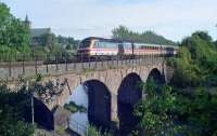 HST heading north over the viaduct just north of Dunblane station. The C&O line was to the right. To the left is the cathedral, with portions of the tower dating from the 11th century.<br><br>[Ewan Crawford //1990]