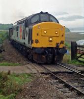 37403 'Glendarroch' at the level crossing immediately east of Loch Eil Outward Bound station with a westbound PW train in 1990. Ben Nevis is barely visible through cloud in the background. [See image 56741] for a more modern shot of this locomotive.<br><br>[Ewan Crawford //1990]