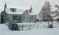 Railway cottage at Tomatin with a small 37402, 47 and LMS locomotive in the garden.<br><br>[Ewan Crawford 31/12/1994]