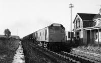 25233 passing through the closed Alves station with a grain train from Burghead, to Elgin, then Aberdeen and I'm told Doncaster. 05 February 1979.<br><br>[Peter Todd 05/02/1979]