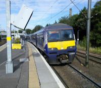 The driver of 320 302 checks the doors on a Larkhall service at Hyndland on<br>
08/10/2016.<br><br>[David Panton 08/10/2016]