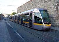 A tram for Tallaght heads south down Steeven's Lane on the Luas 'Red Line'. Dublin Heuston is in the distance. To the right is the west boundary wall of Guinness.<br>
<br><br>[John Steven 09/10/2016]