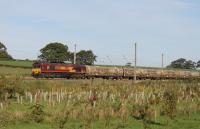 A shiny 66140, still in original EWS livery, hauls a grubby rake of Castle Cement tanks south through the loops at Oubeck on 3rd October 2016. The train is the thrice weekly Mossend to Clitheroe (Horrocksford), which will return to running via the S&C when the Armathwaite landslip has been repaired.<br><br>[Mark Bartlett 03/10/2016]