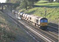 With the extra rails inside the Up line track giving a resemblance of a trough this RHTT train passing Galgate appears to be picking up water rather than spraying it. A grubby DRS 66423 is in the lead with 66429 bringing up the rear on a diagram from Kingmoor that started at 1715hrs the previous evening and covered the WCML, Barrow, Windermere and a return trip along the S&C to Armathwaite before finally going back via Shap to arrive at 1200hrs.  <br><br>[Mark Bartlett 13/10/2016]