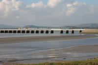 Large logo DRS 37402 propels the 1136 (SO) Carlisle to Lancaster across the Kent Estuary at Arnside on a sunny 15th October 2016. <br><br>[Mark Bartlett 15/10/2016]