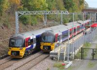 333002 calls at the new station at Apperley Bridge heading for Bradford Forster Square while 333004 speeds through on a Skipton to Leeds service. The station opened in 2015 and has staggered platforms. Its predecessor, on a different site, closed in 1965. [See image 41874] taken at this location in 1979.<br><br>[Mark Bartlett 21/10/2016]