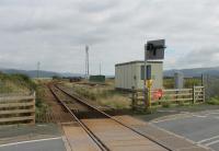 The site of Ynyslas station, closed in 1965, as seen from the level crossing looking towards Dovey Junction on 18th September 2016. Note the grounded coach body by the mast in the old goods yard. [See image 56589].<br><br>[Mark Bartlett 18/09/2016]