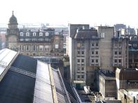 View over the trainshed roof towards Consort House (centre right), the former headquarters of Strathclyde Partnership for Transport, which is also due for demolition in the second phase of the Glasgow Queen Street redevelopment. Work is due to resume in November 2016. To the left above the station can be seen the rather more pleasing building that is the 1877 Merchants House of Glasgow, fortunately not obscured from this angle by the Millenium Hotel extension which adjoins Consort House.<br><br>[Colin McDonald 10/10/2016]