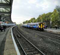 The evening service to Newcastle at Kilmarnock on 15/10/2016. Behind the trees there is a smart new college building in the place of the Johnnie Walker plant which once dominated this scene.<br><br>[David Panton 15/10/2016]