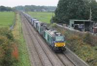 The usual long, long line of container wagons that make up the Daventry to Mossend <I>Tesco Express</I> head north through Woodacre behind DRS 68025 <I>Superb</I> and 68023 <I>Achilles</I> on 14th October 2016.<br><br>[Mark Bartlett 14/10/2016]
