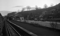 Thanks to its location in the lee of the Eildons, sunrise comes late to Melrose in the middle of winter and even at 10:20 on the bright morning of Saturday 4th January 1969, the station in still in shadow as BR Scottish Grand Tour No. 6, hauled by Brush Type 4 No. D1974, makes a brief stop there.<br><br>[Bill Jamieson 04/01/1969]