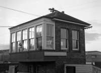 At 10:27, the sun is reflected off the front windows of St. Boswells South box, again photographed from Scottish Grand Tour No.6 on Saturday 4th January 1969. Although it had outlived the North box by almost three years, South box now only had less than twelve hours of life left, closing at 21:49 that same day once Brush Type 4 No. 1974 (it certainly had a busy day!) had left the St. Boswells South to Hawick South section on its way light engine to Carlisle to take over the 21:27 Manchester Exchange - Aberdeen newspaper train. For the remainder of the last weekend of the Waverley Route, Hawick South box would work through to Galashiels.<br><br>[Bill Jamieson 04/01/1969]