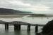 With the Barmouth Viaduct in the foreground, this view looks across the estuary to the Ferry terminus of the Fairbourne Railway on 19th September 2016. A wisp of steam by the building indicates a train has just arrived from Fairbourne. <br><br>[Mark Bartlett 19/09/2016]