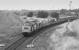 37153 takes an ECML electrification train over the East/south chord at Millerhill in 1990.  In the right background is the wagon repair shop while to the left is the cleared Waverley Route trackbed.<br><br>[Bill Roberton //1990]