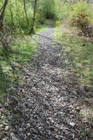 View south to Slitrig (or Lynnwood) Viaduct, south of Hawick. Here for a mile or so the ballast remains intact. The ballast provides a useful source of drainage stones for local use I'm told!<br><br>[Ewan Crawford 05/05/2014]