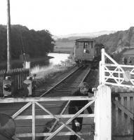 Guard Scott closing the gate at Abbotsford Ferry in 1962 following passage of the Selkirk goods. The line closed completely in 1964. [See image 21994].<br><br>[Dougie Squance (Courtesy Bruce McCartney) //1962]