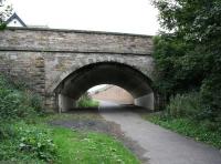 The solid looking structure carrying the A199 over the trackbed of the Tranent Goods branch, seen here shortly after entering the town heading north towards the site of the Goods station on Elphinstone Road. The apex of the roof of <I>The Brig Inn</I> is visible top left. [See image 56597]<br><br>[John Furnevel 18/09/2016]