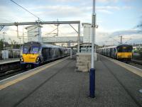 334 008 pulls out with a westbound service while 318 254 sits in the bay. Trains from Balloch are timed to arrive shortly after the last one going the other way has departed, so that Platform 1, on the right, is occupied for most of the time. Photographed 22/10/2016.<br><br>[David Panton 22/10/2016]