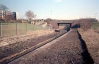 The trackbed from Paisley Abercorn to Sandyford Halt was converted into one of the less successful foot/cycleways in 1987. This view looks towards Arkleston Junction during the conversion. The walking route, largely hemmed in by fencing, took in a sewage works and the M8's White Cart Viaduct. Abercorn station was provided on the curved line to connect the old railway to the network and replaced the Hamilton Street terminus. [Ref query 70]<br><br>[Ewan Crawford //1987]