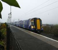 380 112 waits to leave with its passengers off the Arran Ferry on the drizzly morning of 29/10/2016.<br>
<br>
Ardrossan Harbour is the recipient of a Bronze station award, details of these awards can be found on the <a target=external href=http://www.keepscotlandbeautiful.org/local-environmental-quality/local-environmental-quality-network/news/scotlands-railway-stations-setting-new-environmental-standards/>Keep Scotland Beautiful</a> website.<br><br>[David Panton 29/10/2016]