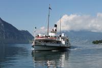 Flagship of the fleet of 21 vessels operated by the Lake Lucerne Navigation Company, <I>PS Stadt Luzern</I> slows to call at the pier at Weggis on 29th June 2016. This is the largest vessel on the lake, with a capacity of 1200 passengers, and one of five operational paddle steamers in the fleet. Behind the ship, with its summit shrouded in cloud, is Mount Pilatus which has the steepest cog railway in the world connecting with the Lucerne steamers at Alpnachstad.<br><br>[Mark Bartlett 29/06/2016]