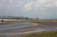 A Sprinter <I>Bubble Car</I> leaves Arnside and trundles over the Kent Viaduct approach causeway with a Lancaster to Barrow-in-Furness service on 15th October 2016. The Northern single units now mainly operate in pairs on this line. <br><br>[Mark Bartlett 15/10/2016]