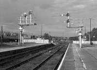 Dramatic lighting at Barrow in Furness on the late morning of Friday 21st October 2016. The view is looking north-west towards the carriage sidings which have plenty of space free to accommodate the Pacer unit which has just arrived on the terminating 10:04 from Preston and has the calling-on signal cleared for it. This train should have been a class 37 and coaches - I bet the many enthusiasts waiting for it at Preston and Lancaster expecting haulage (and a comfortable trip) were really pleased! The platform 3 down starter on the extreme right is 'off' for the 11:40 departure to Carlisle, which was class 37 worked.<br><br>[Bill Jamieson 21/10/2016]