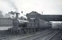 Ex-LNWR Webb 2-4-2T 46635 at Dumfries shortly after sunrise on 18 April 1949 with the Lockerbie push-pull train. The 1892 veteran was finally withdrawn in April 1950 from Dumfries shed, the roof of which can be seen above St Mary's Street road bridge in the background.  <br><br>[G H Robin collection by courtesy of the Mitchell Library, Glasgow 18/04/1949]