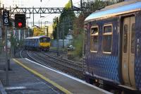 320301 waits for the road into the turnback siding as 318266 heads west to Balloch.  7 November.<br><br>[Bill Roberton 07/11/2016]