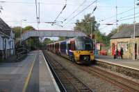 WYPTE EMU 333014 slows for the Menston stop with an Ilkley to Leeds service on 21st October 2016. Unlike the other intermediate stations on the Ilkley branch the original station buildings at Menston are still in railway use.<br><br>[Mark Bartlett 21/10/2016]