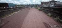 Looking south towards Scotland Street Junction over the approach to General Terminus not long after track lifting in 1987. The location was reached via an approach eight tracks wide. This city centre location, latterly used to import iron ore for Ravenscraig before being eclipsed by Hunterston, was dismantled in late 1986 after a long period of little use. The trackbed seen here was used as a car park and access to the Glasgow Garden Festival site in 1988. The cutting has since been filled in and redeveloped.<br><br>[Ewan Crawford //1987]