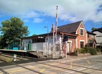 Looking NE over the crossing at the former station building, the outline of the former ticket office window can be seen in the white painted brickwork. [Ref query 97]<br><br>[Ken Strachan 07/08/2016]