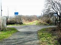 Site of the flat crossing of the lines from Granton and North Leith at Bonnington in March 2003. View is southeast towards Powderhall where the line currently terminates at the refuse disposal depot on Broughton Road, which can be seen in the right background. Off to the left is the former route to North Leith while to the right lies Warriston Junction, Scotland Street and, long ago, Canal Street. <br><br>[John Furnevel 10/03/2003]